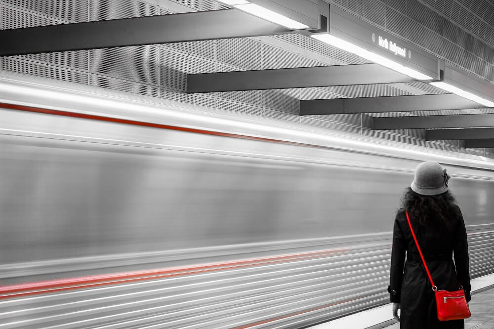 Woman at subway with bright red purse